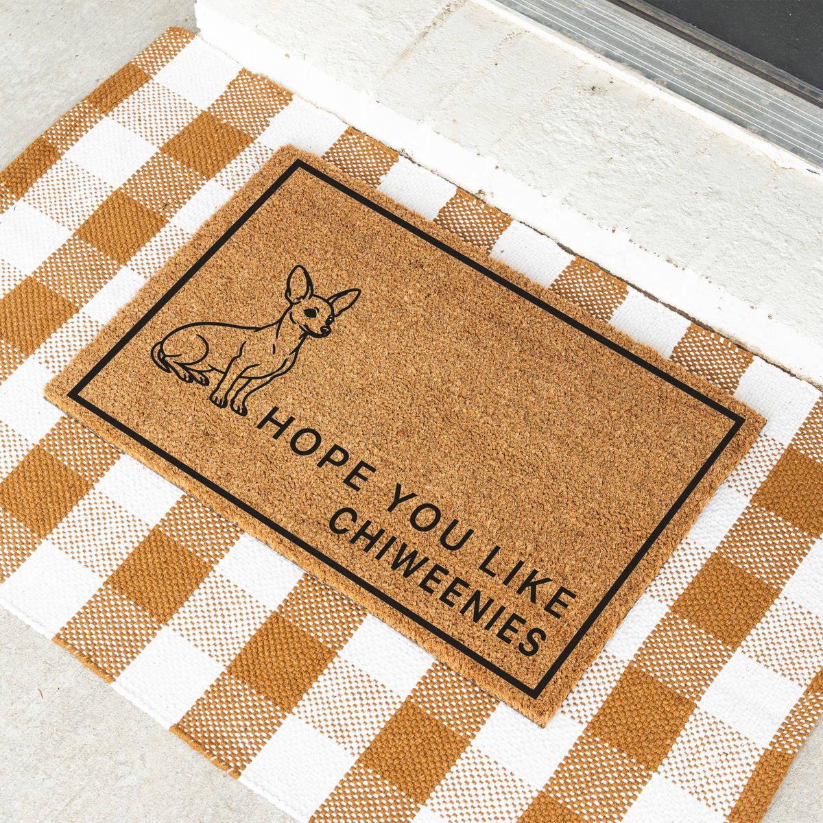 Hope You Like Chiweenies coir doormat with a drawing of a sitting Chiweenie at an angle on a tan and white check rug