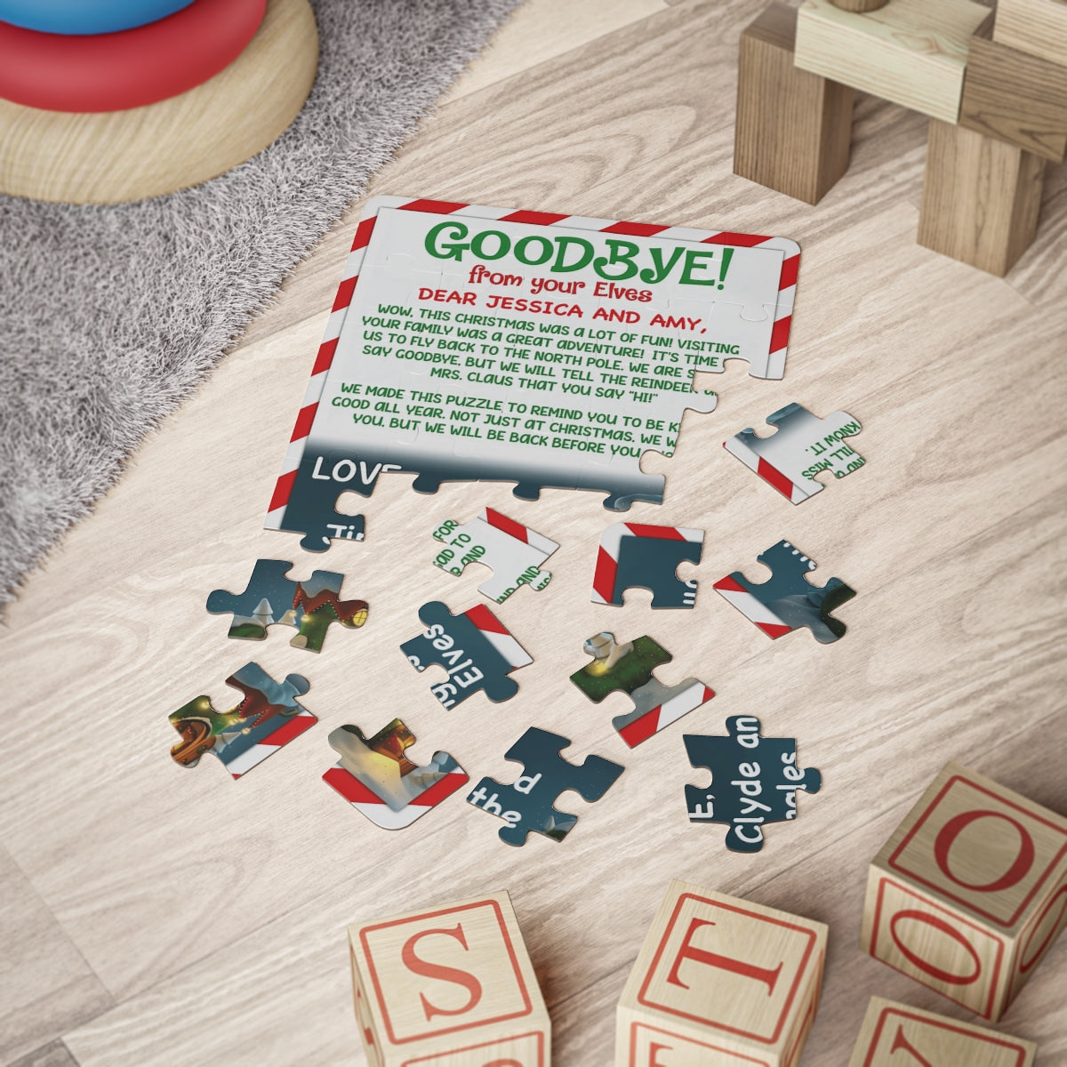 Goodbye from your Elves candy cane border personalized jigsaw puzzle partly assembled beside wooden toy blocks