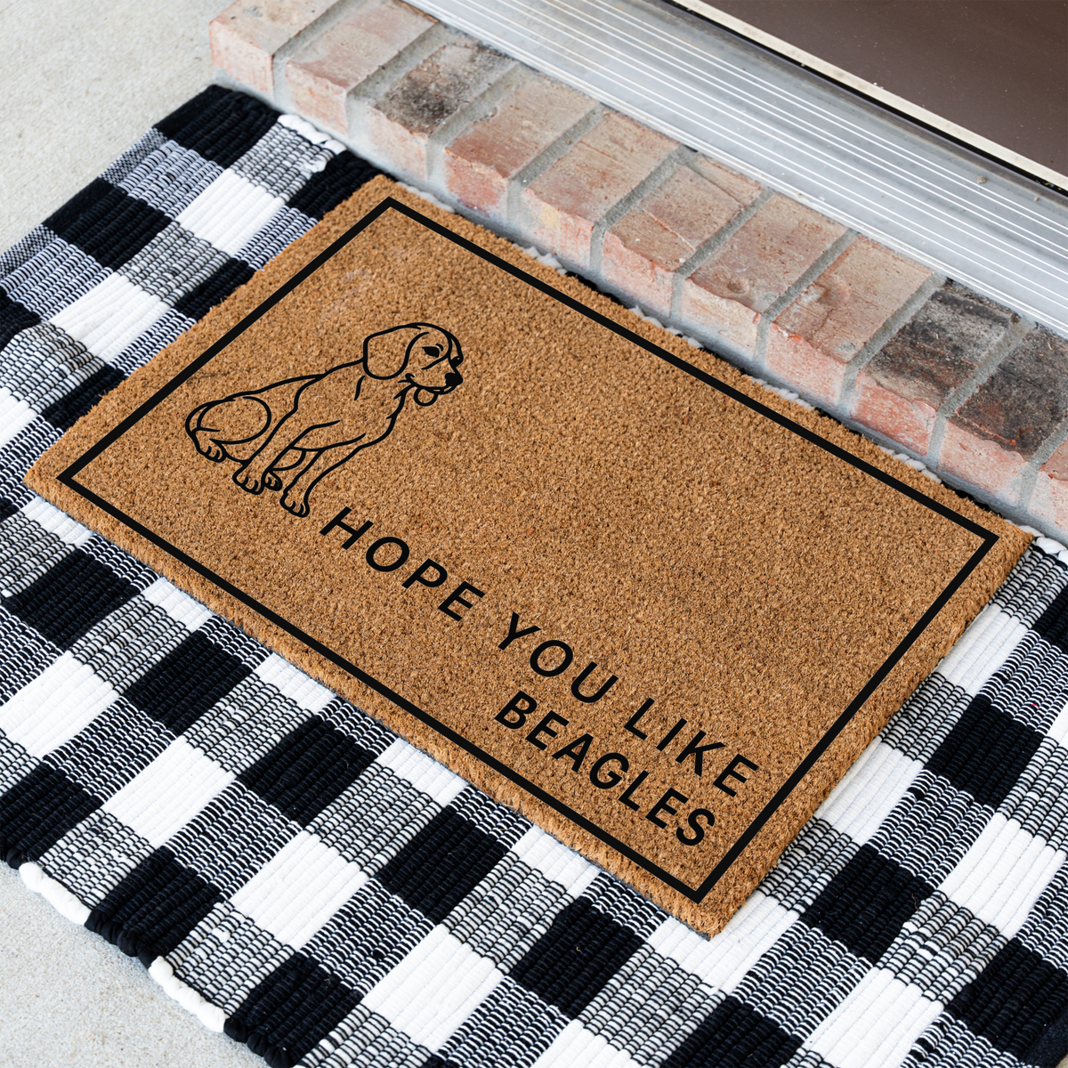 Hope You Like Beagles coir doormat with a drawing of a sitting beagle at an angle on a black and white buffalo check rug