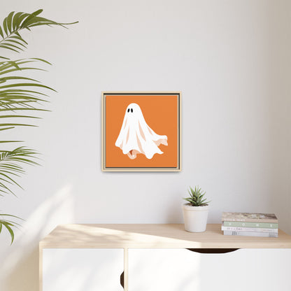 Orange ghost canvas print in a natural frame on a light living room wall