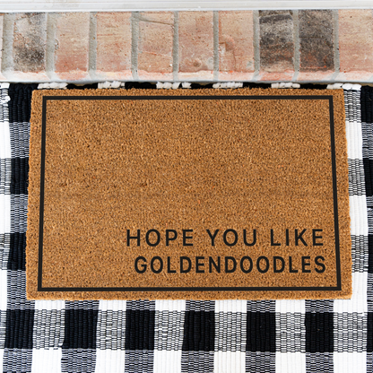 Hope You Like Goldendoodles minimalist coir doormat with a thin black border on a black and white buffalo check rug, close view