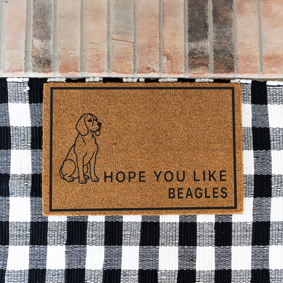 Hope You Like Beagles coir doormat with a drawing of a sitting beagle on a black and white buffalo check rug at a brick step