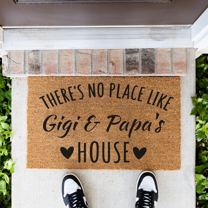 There's No Place Like Gigi & Papa's House coir doormat in front of a brick step, top-down view