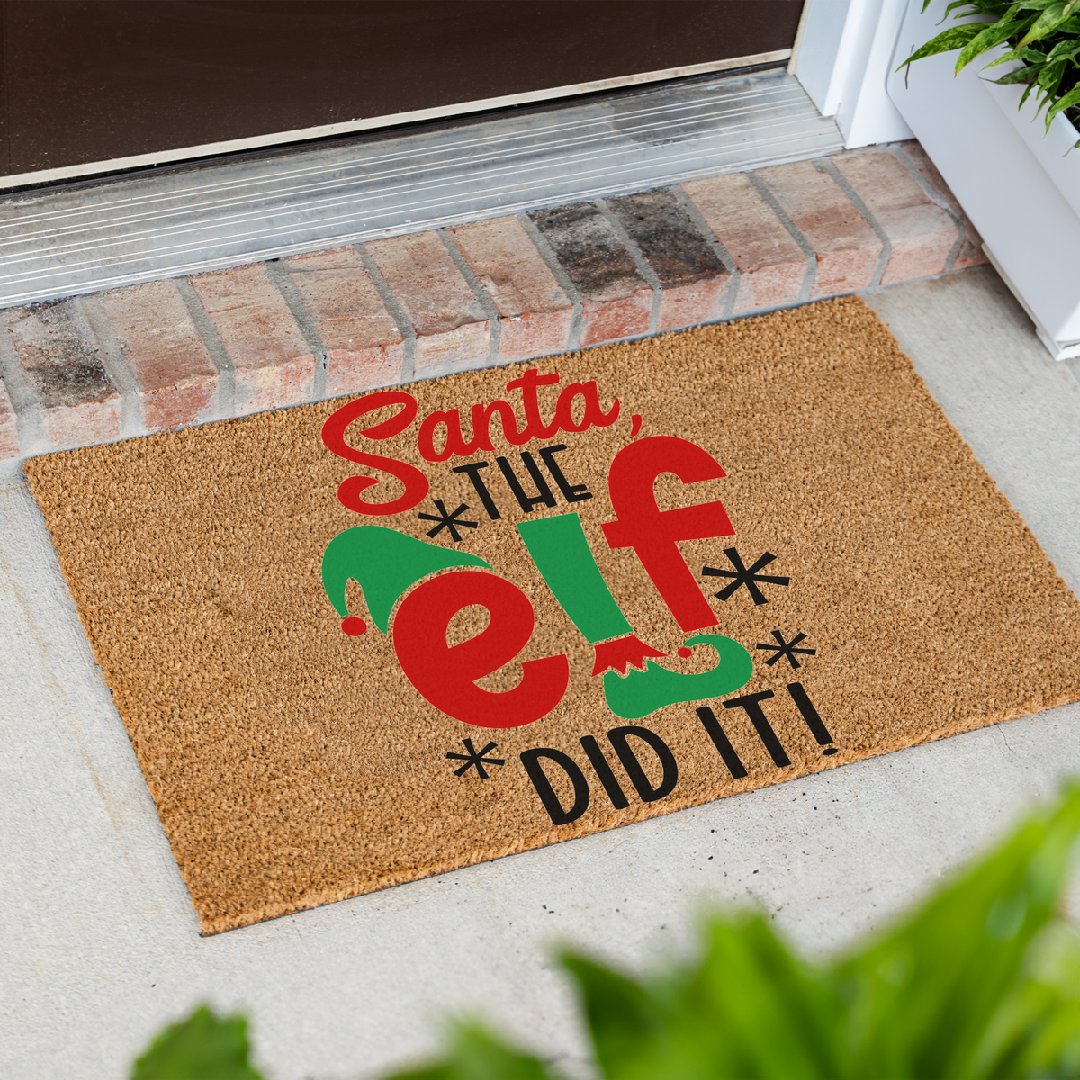 Santa The Elf Did It coir doormat at an angle in front of a brick step