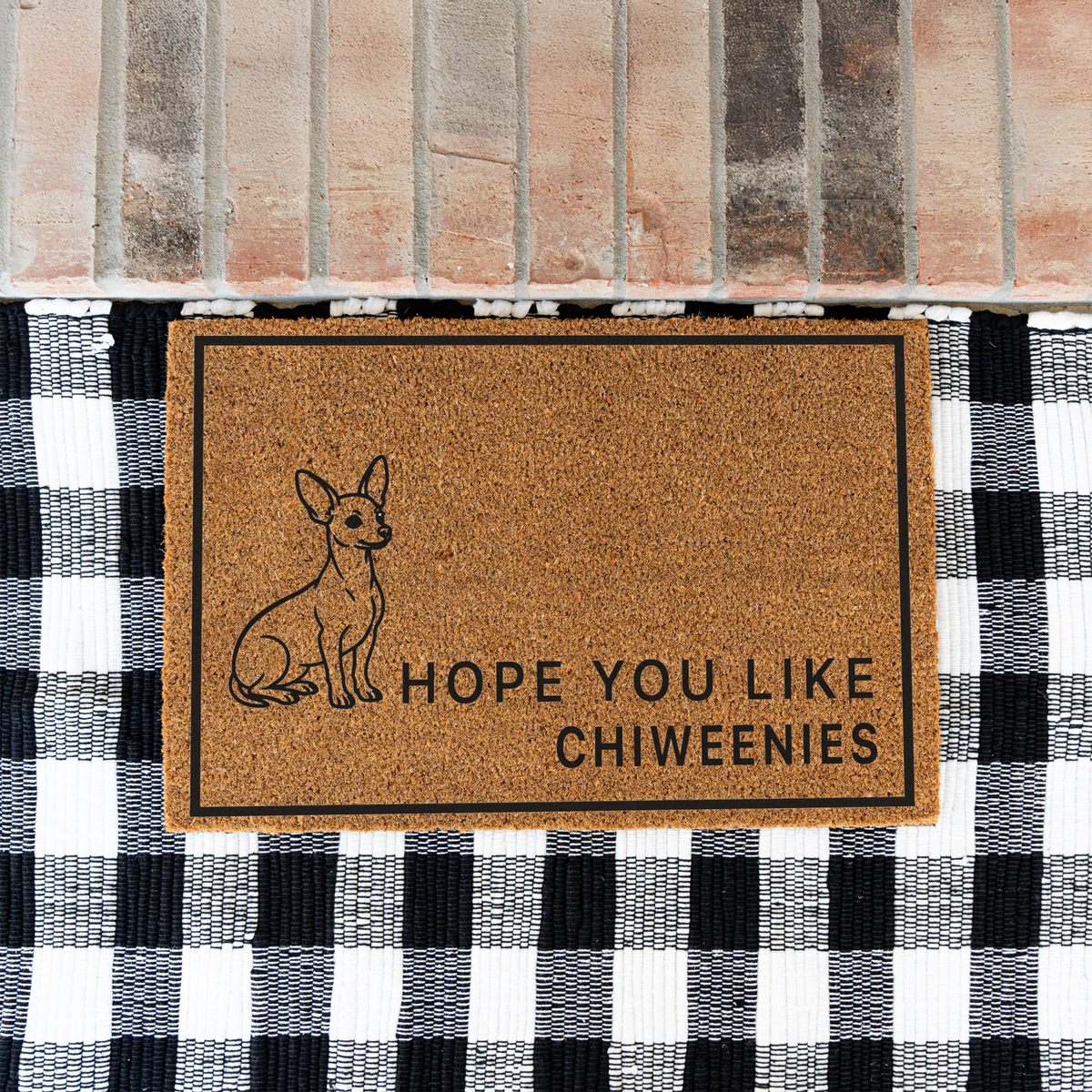 Hope You Like Chiweenies coir doormat with a drawing of a sitting Chiweenie on a black and white buffalo check rug at a brick step