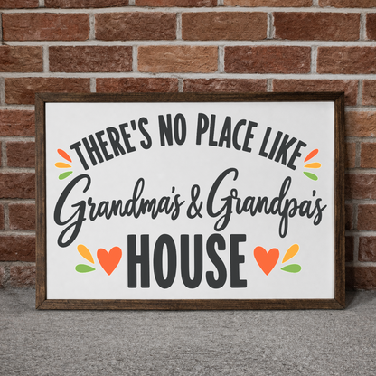There's No Place Like Grandma's & Grandpa's House framed sign with a walnut frame leaning on a brick wall
