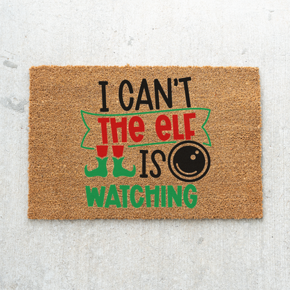 I Can't The Elf Is Watching coir doormat on light gray concrete