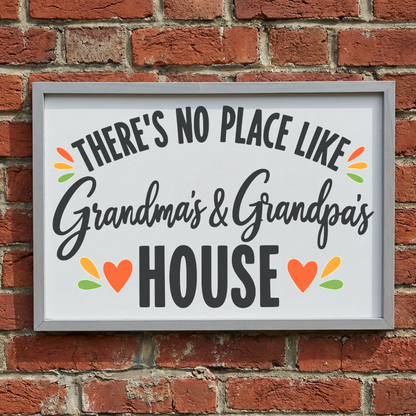 There's No Place Like Grandma's & Grandpa's House framed sign with a grey frame leaning on a red brick wall