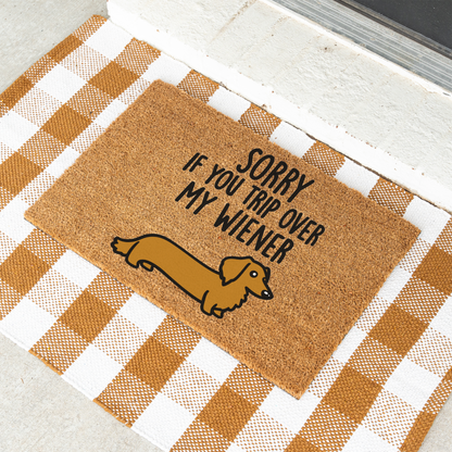 Sorry If You Trip Over My Wiener dachshund coir doormat on a tan and white check rug