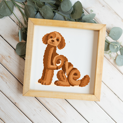 Sitting red doodle Love square framed sign with a natural wood frame on white wood planks with eucalyptus