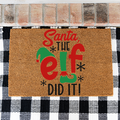 Santa The Elf Did It coir doormat on a black and white buffalo check rug, close view