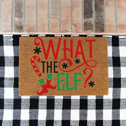 What The Elf coir doormat on a black and white buffalo check rug at a brick step