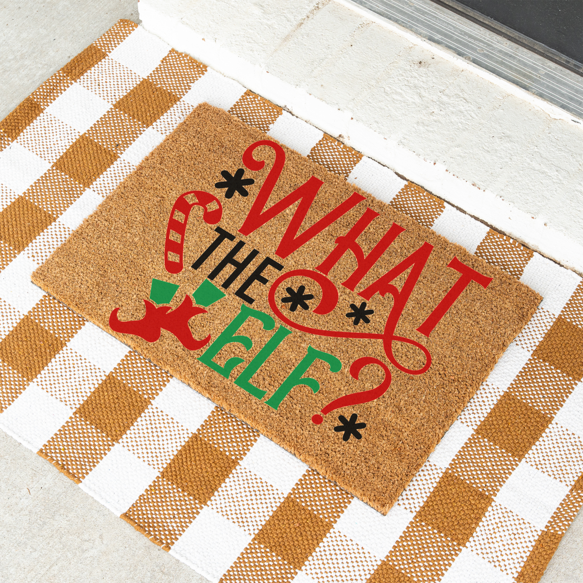 What The Elf coir doormat on a tan and white check rug
