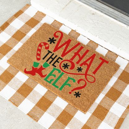What The Elf coir doormat on a tan and white check rug