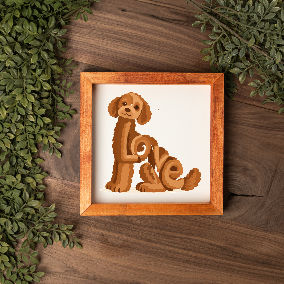 Sitting red doodle Love square framed sign with a stained wood frame on a dark wood table with greenery