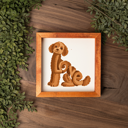 Sitting red doodle Love square framed sign with a stained wood frame on a dark wood table with greenery