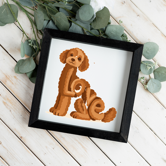 Sitting red doodle Love square framed sign with a black frame on white wood planks with eucalyptus