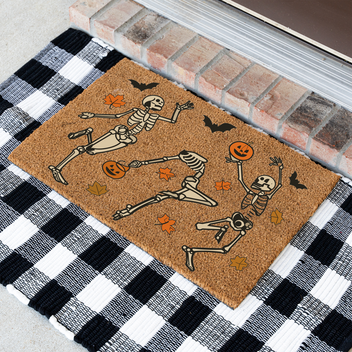 Dancing skeletons Halloween coir doormat at an angle on a black and white buffalo check rug