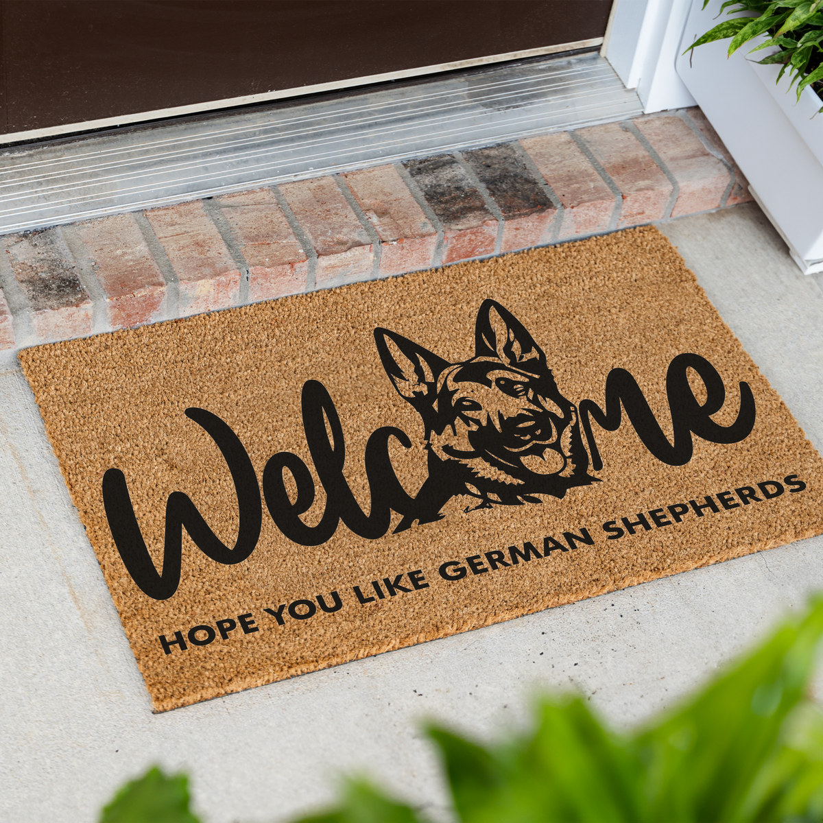 Welcome Hope You Like German Shepherds coir doormat with a German shepherd head in the word welcome at an angle in front of a brick step