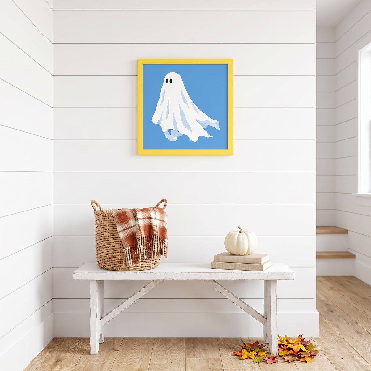 Blue ghost framed art print in a yellow frame, 16 x 16 inch size, hanging above a white bench on a shiplap wall