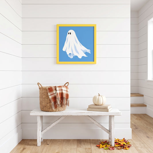 Blue ghost framed art print in a yellow frame, 16 x 16 inch size, hanging above a white bench on a shiplap wall