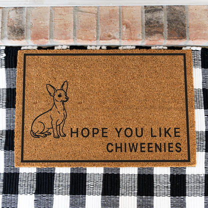 Hope You Like Chiweenies coir doormat with a drawing of a sitting Chiweenie on a black and white buffalo check rug, close view