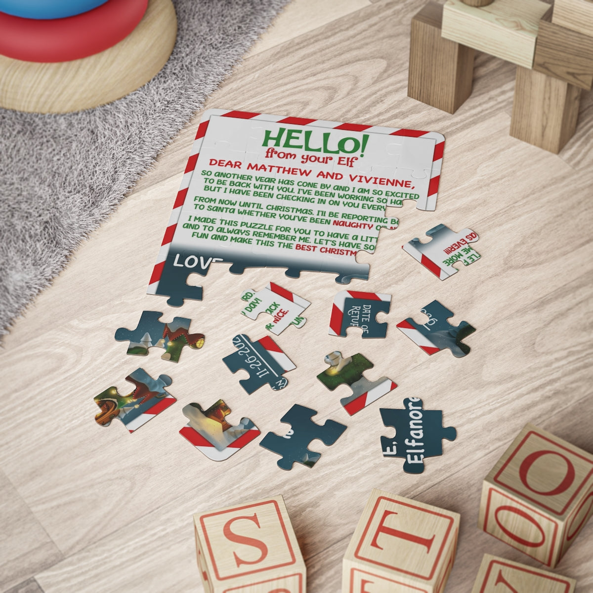 Hello from your Elf candy cane border personalized jigsaw puzzle partly assembled beside wooden toy blocks