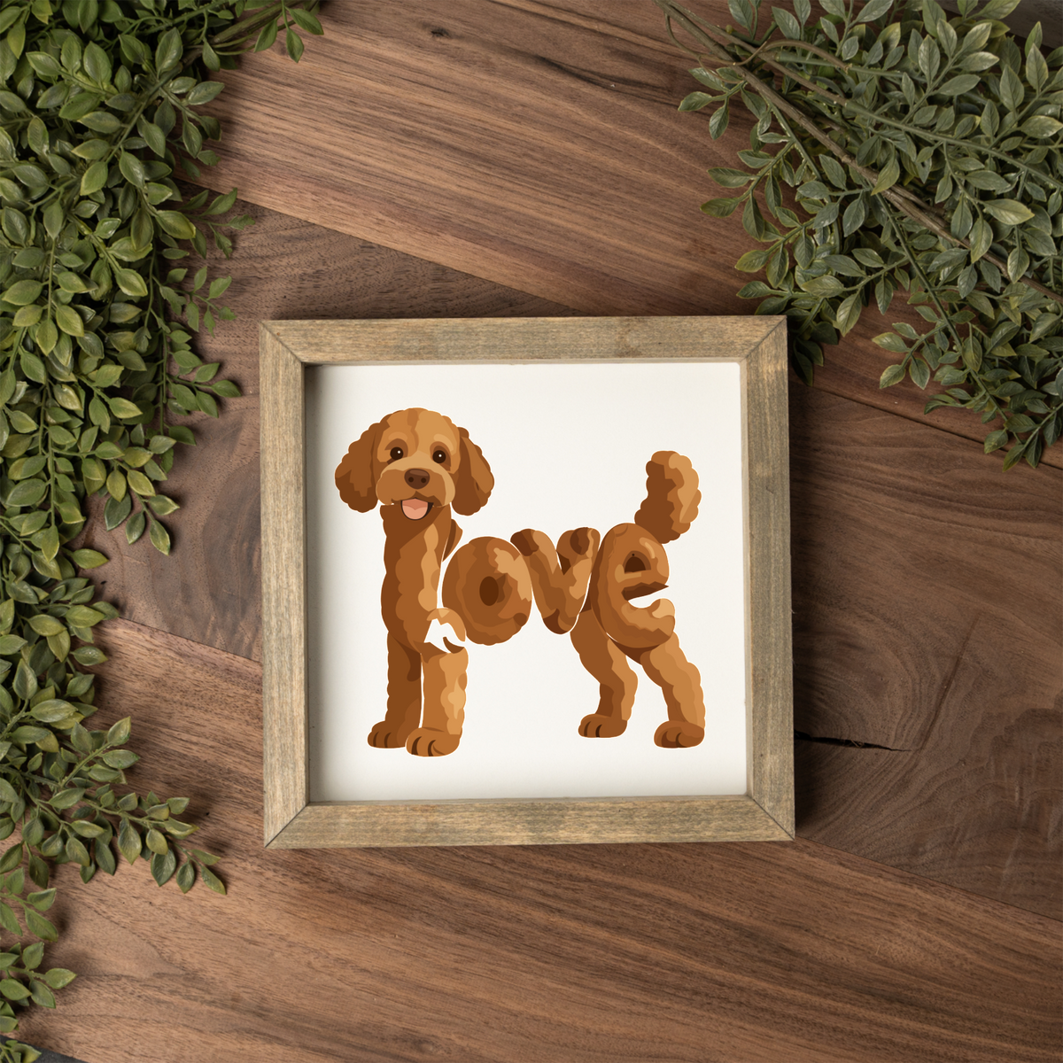 Standing red doodle love square framed sign with a weathered wood frame on a dark wood table with greenery