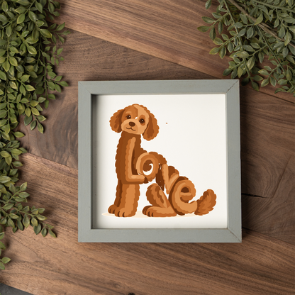 Sitting red doodle Love square framed sign with a grey frame on a dark wood table with greenery