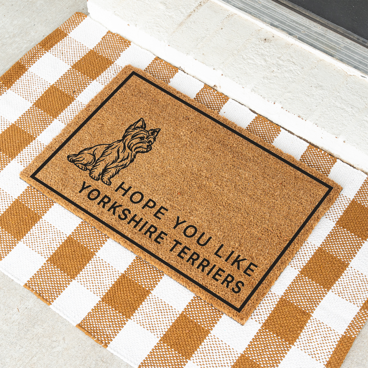 Hope You Like Yorkshire Terriers coir doormat with a drawing of a sitting Yorkshire terrier at an angle on a tan and white check rug