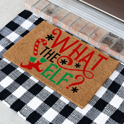 What The Elf coir doormat at an angle on a black and white buffalo check rug