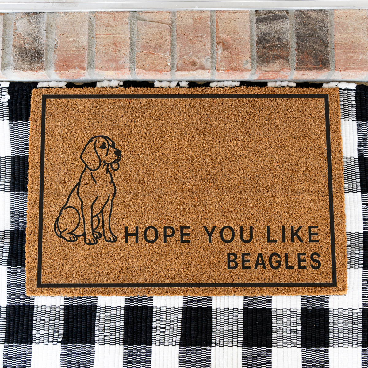 Hope You Like Beagles coir doormat with a drawing of a sitting beagle on a black and white buffalo check rug, close view