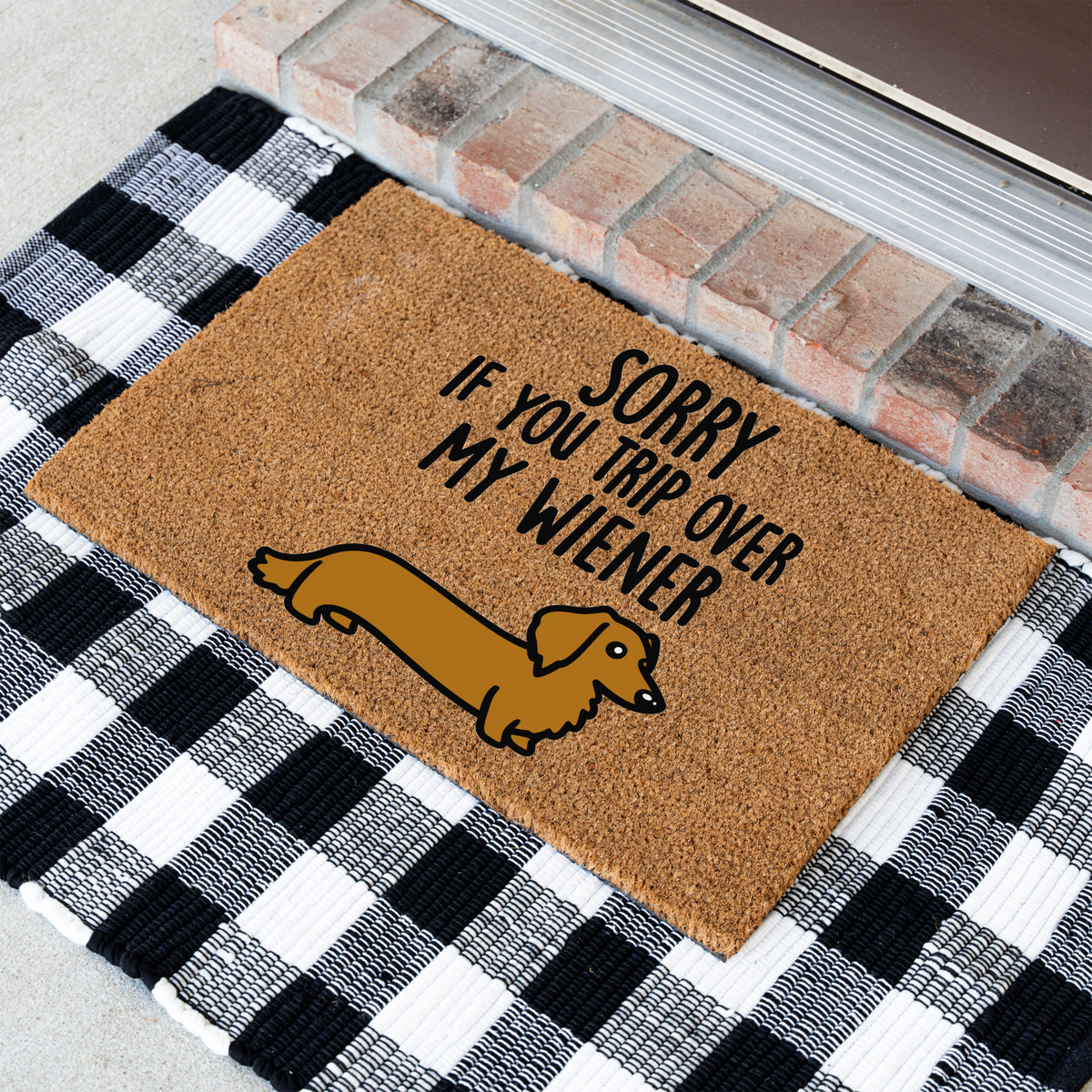 Sorry If You Trip Over My Wiener dachshund coir doormat at an angle on a black and white buffalo check rug