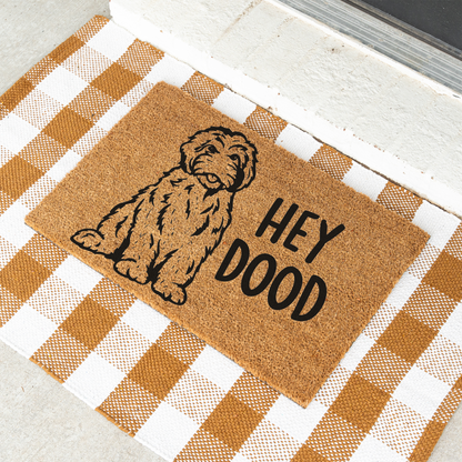 Hey Dood doodle dog coir doormat on a tan and white check rug