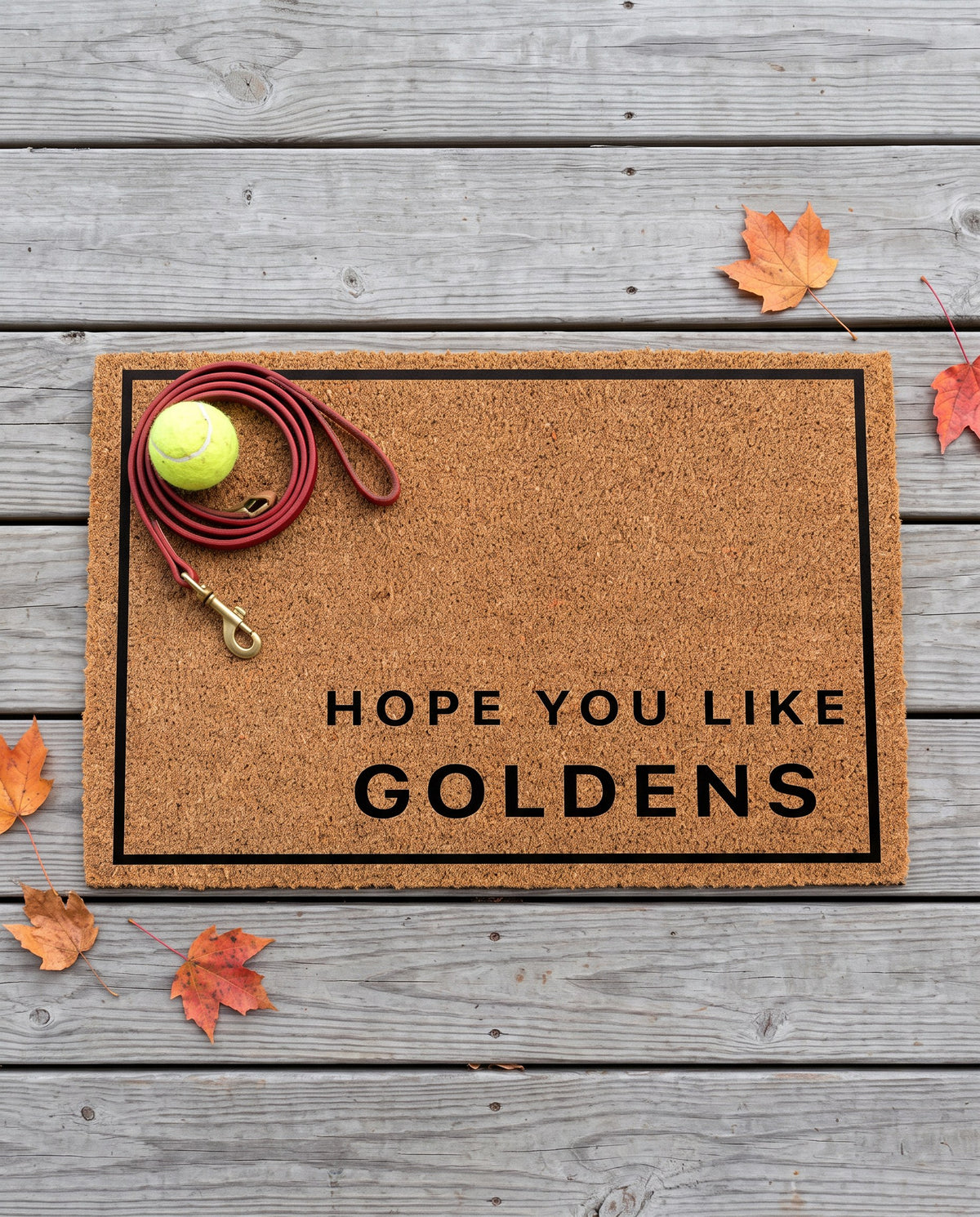 Hope You Like Goldens minimalist coir doormat with a tennis ball and dog leash on it