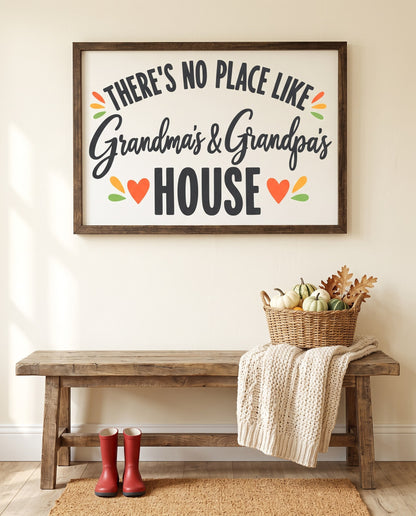 There's No Place Like Grandma's & Grandpa's House framed sign with a walnut frame, shown in 36x24, hanging above a rustic entryway bench with pumpkins and kids' rain boots