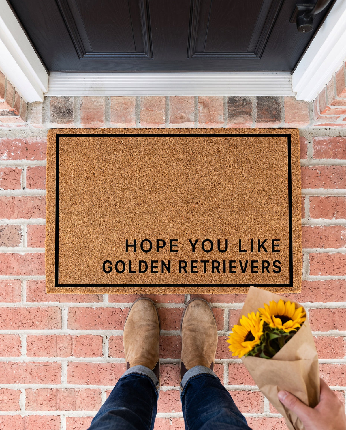 Hope You Like Golden Retrievers minimalist coir doormat on a brick stoop with a guest holding sunflowers