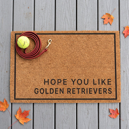 Hope You Like Golden Retrievers minimalist coir doormat with a tennis ball and dog leash on it