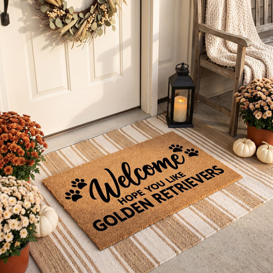 Welcome Hope You Like Golden Retrievers coir welcome mat with paw prints on a striped jute rug on a styled fall porch